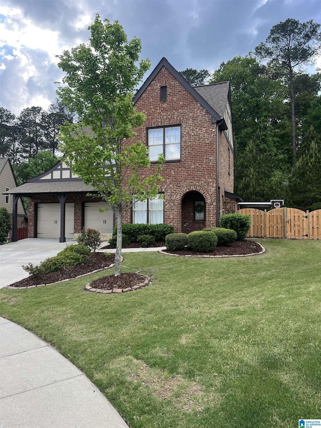 view of front facade featuring a front yard, a gate, brick siding, fence, and concrete driveway