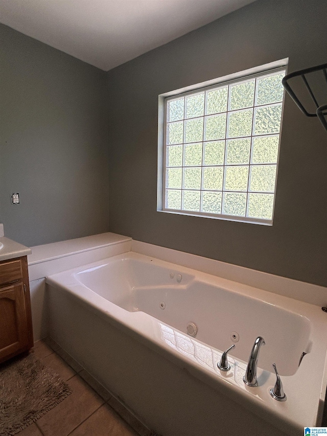 41 Woodland Ridge Rd, Odenville, AL 35120 - bathroom featuring a tub with jets, tile patterned flooring, and vanity