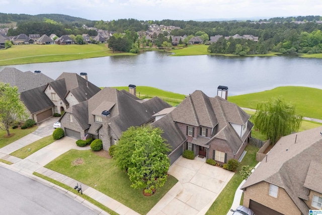 drone / aerial view featuring a residential view and a water view