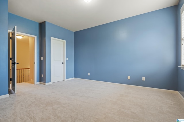 unfurnished bedroom with carpet flooring and baseboards