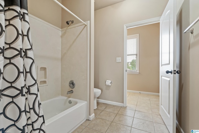 full bathroom with baseboards, shower / tub combo, toilet, and tile patterned flooring
