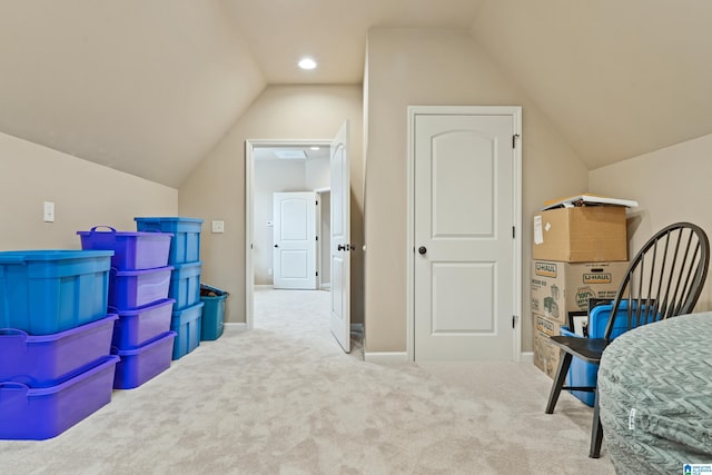 interior space featuring vaulted ceiling, carpet, and baseboards