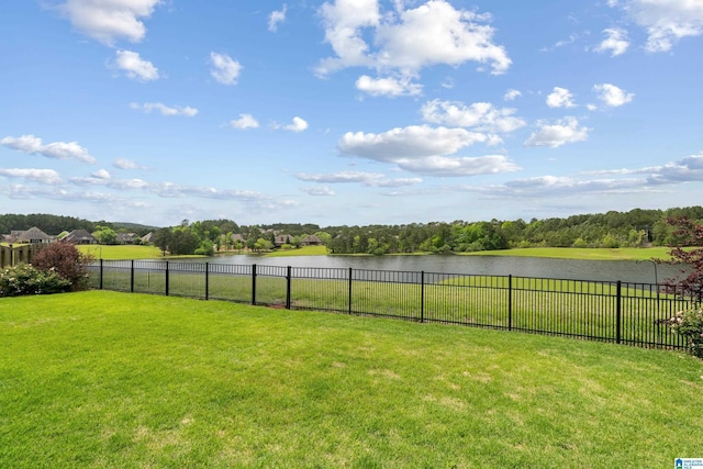 view of yard featuring a water view and fence