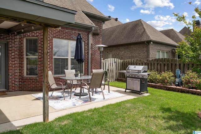view of patio featuring area for grilling and fence
