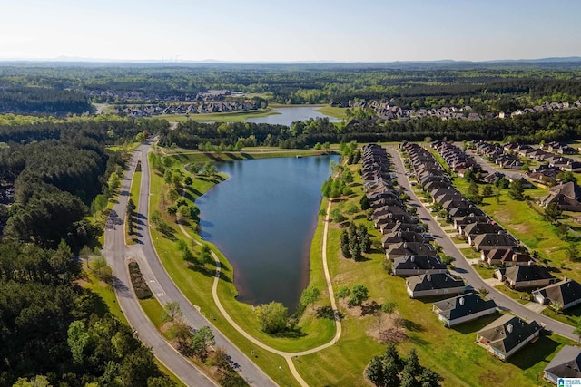 drone / aerial view featuring a residential view, a water view, and a wooded view