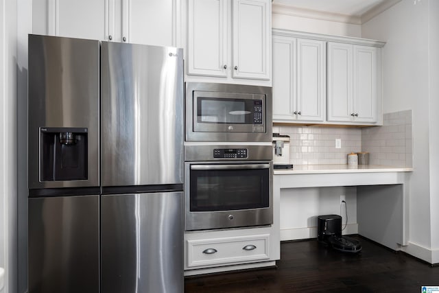 kitchen with dark wood-style flooring, decorative backsplash, light countertops, ornamental molding, and appliances with stainless steel finishes