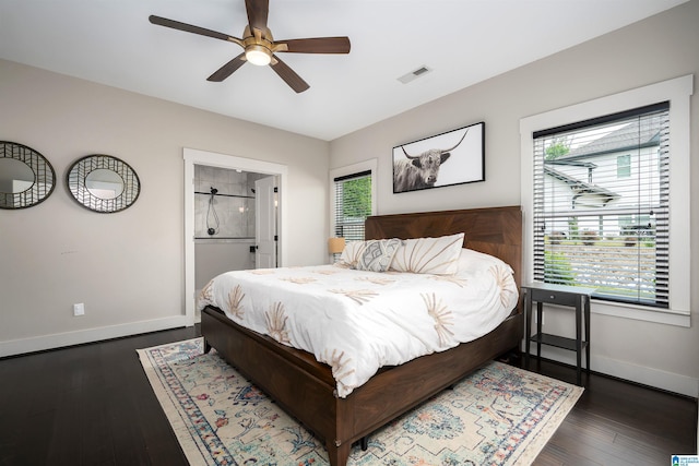 bedroom with dark wood-type flooring, visible vents, multiple windows, and baseboards