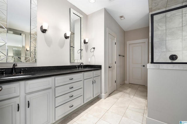 bathroom featuring double vanity, visible vents, tile patterned floors, and a sink