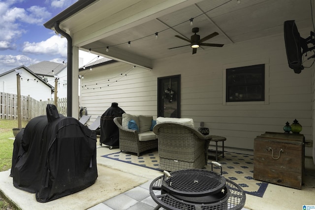 view of patio featuring fence, area for grilling, a ceiling fan, and an outdoor hangout area