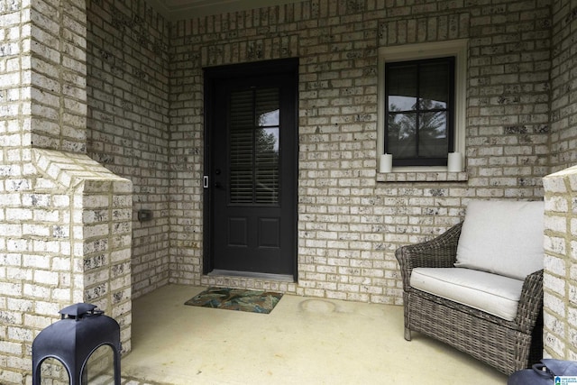 view of exterior entry with brick siding
