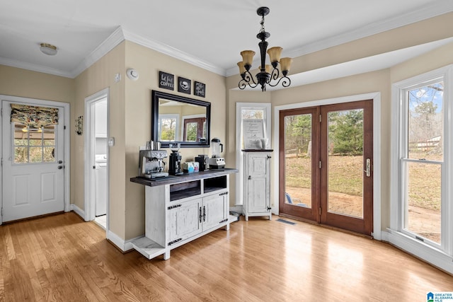 1938 Pleasant Ridge Loop, Sylacauga, AL 35150 - entryway featuring light wood-style floors, crown molding, a chandelier, and baseboards