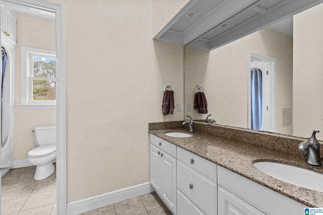 1938 Pleasant Ridge Loop, Sylacauga, AL 35150 - bathroom featuring baseboards, tile patterned floors, toilet, and a sink