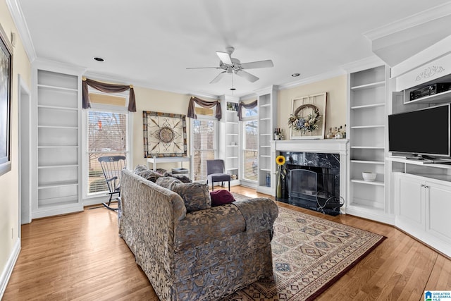 1938 Pleasant Ridge Loop, Sylacauga, AL 35150 - living room with crown molding, light wood-style flooring, a ceiling fan, and built in features