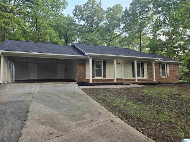 841 Olde Mill Trce, Cottondale, AL 35453 - ranch-style house featuring driveway, brick siding, an attached carport, and a porch