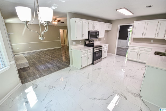 841 Olde Mill Trce, Cottondale, AL 35453 - kitchen with stainless steel appliances, baseboards, a chandelier, and light countertops