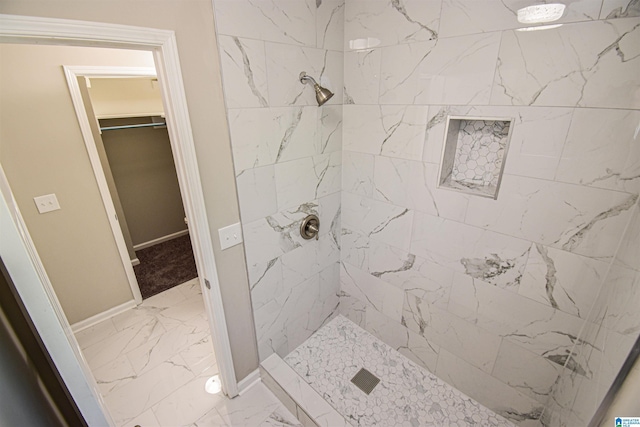 841 Olde Mill Trce, Cottondale, AL 35453 - bathroom featuring marble look tiles, a tile shower, and baseboards