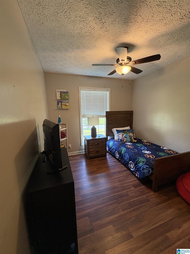 bedroom with a textured ceiling, ceiling fan, and wood finished floors