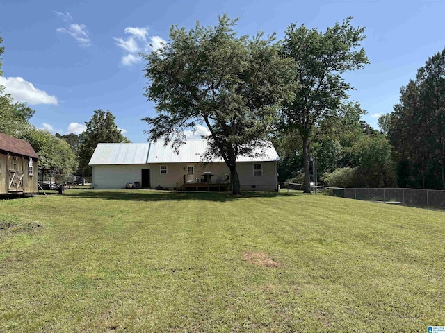 view of yard featuring fence and a wooden deck