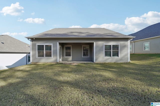 back of property featuring a lawn
