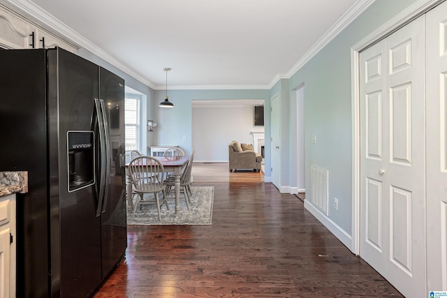 165 Ashford Ln, Alabaster, AL 35007 - interior space with crown molding, dark wood-style flooring, black refrigerator with ice dispenser, and visible vents