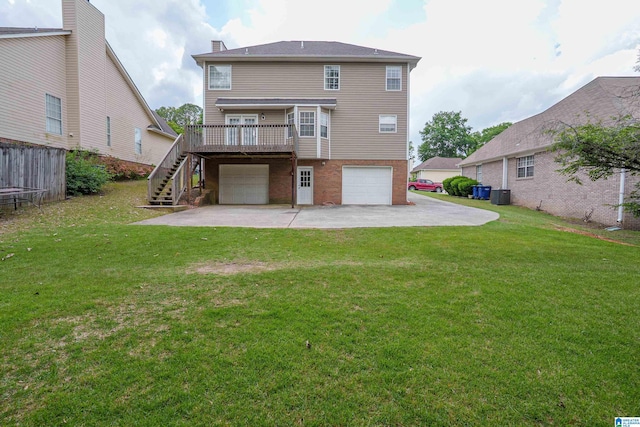 165 Ashford Ln, Alabaster, AL 35007 - back of property with a lawn, a wooden deck, an attached garage, driveway, and stairway