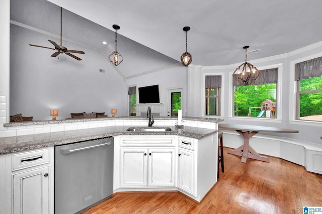 kitchen featuring lofted ceiling, a sink, open floor plan, dishwasher, and ceiling fan with notable chandelier