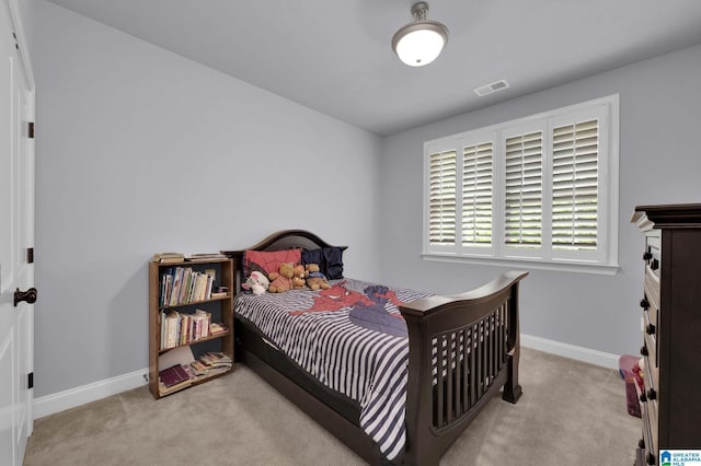 carpeted bedroom with visible vents and baseboards