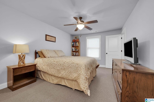 carpeted bedroom featuring visible vents, a ceiling fan, and baseboards