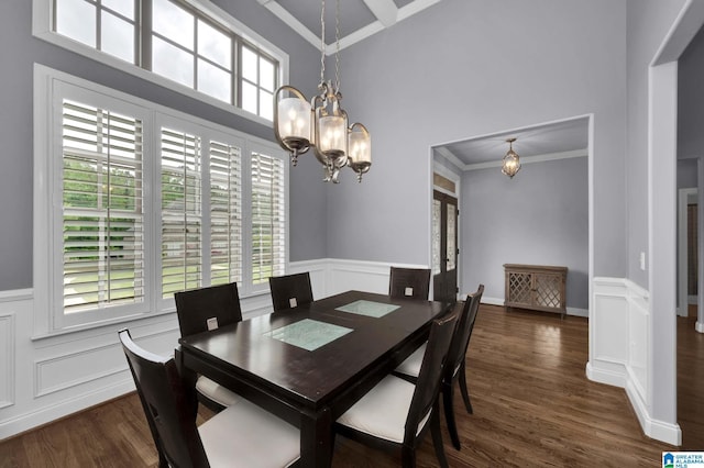 dining area with a chandelier, plenty of natural light, and ornamental molding