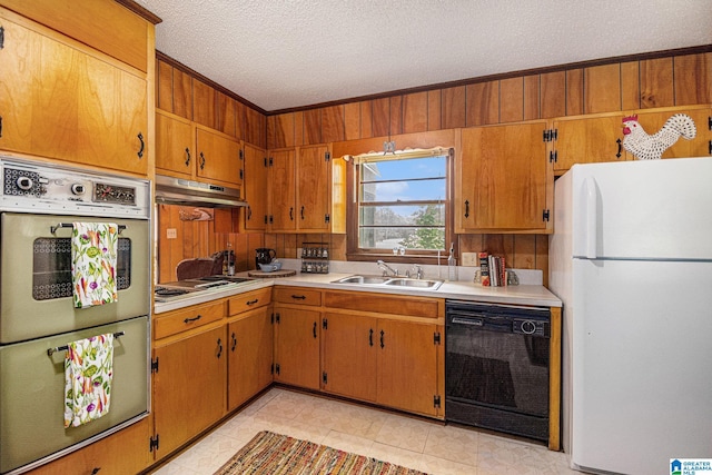kitchen with stainless steel electric cooktop, freestanding refrigerator, under cabinet range hood, black dishwasher, and multiple ovens