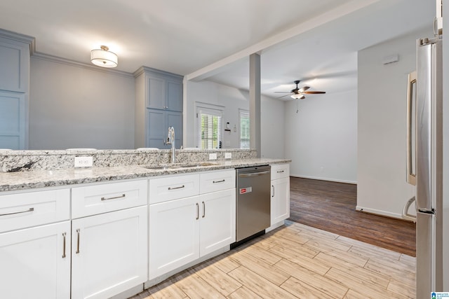 2607 Woodfern Ct, Homewood, AL 35209 - kitchen featuring ceiling fan, light stone countertops, a sink, light wood finished floors, and stainless steel appliances