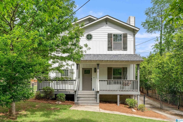 2607 Woodfern Ct, Homewood, AL 35209 - view of front of property featuring roof with shingles, fence, covered porch, and a chimney