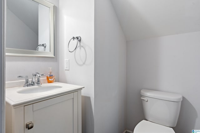 2607 Woodfern Ct, Homewood, AL 35209 - bathroom with toilet, vaulted ceiling, and vanity