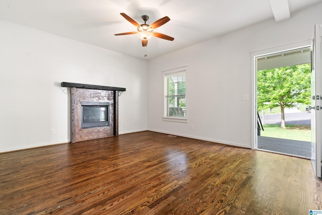 2607 Woodfern Ct, Homewood, AL 35209 - unfurnished living room featuring baseboards, ceiling fan, a tiled fireplace, and wood finished floors