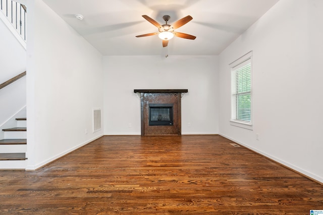 2607 Woodfern Ct, Homewood, AL 35209 - unfurnished living room featuring a tiled fireplace, stairs, a ceiling fan, wood finished floors, and visible vents