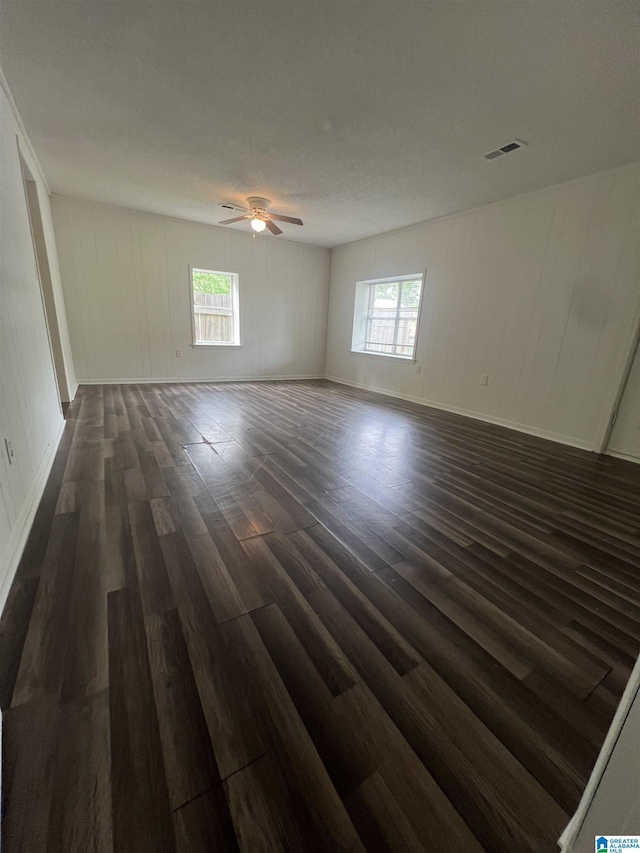 1701 Mount Pleasant Rd, Clanton, AL 35045 - unfurnished room featuring dark wood finished floors, visible vents, ceiling fan, and a healthy amount of sunlight