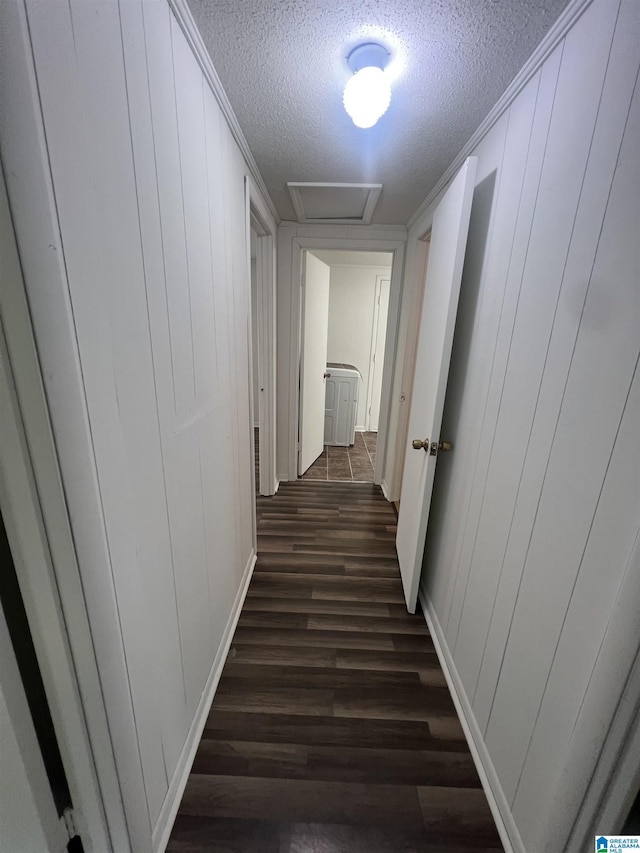 1701 Mount Pleasant Rd, Clanton, AL 35045 - hall featuring attic access, a textured ceiling, dark wood-style flooring, and a decorative wall