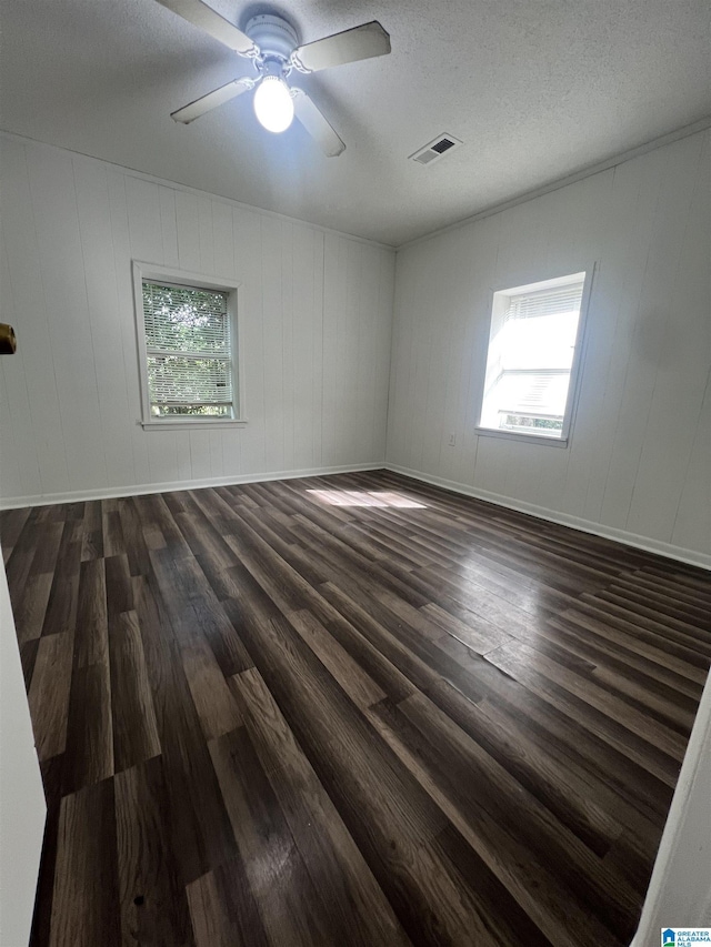 1701 Mount Pleasant Rd, Clanton, AL 35045 - spare room with dark wood-style floors, a textured ceiling, ceiling fan, and visible vents