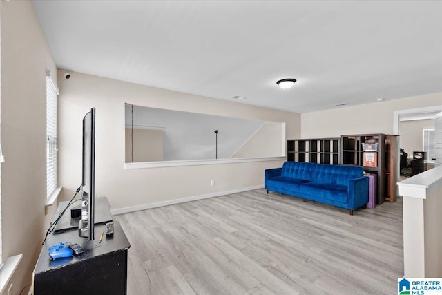 unfurnished living room with baseboards and wood finished floors