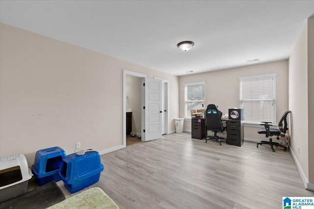 office space featuring baseboards and wood finished floors