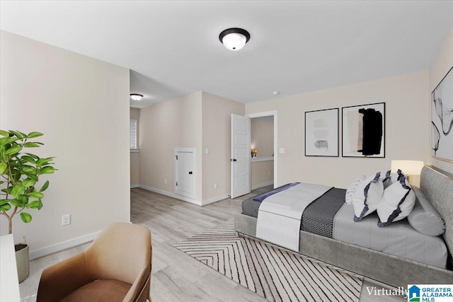 bedroom featuring baseboards and light wood-style floors