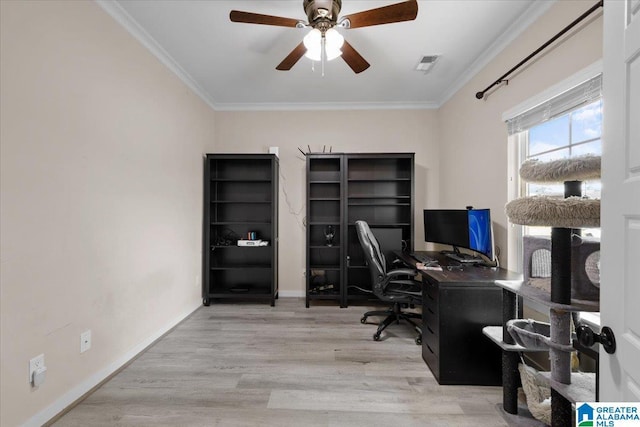 office area with a ceiling fan, baseboards, wood finished floors, visible vents, and ornamental molding