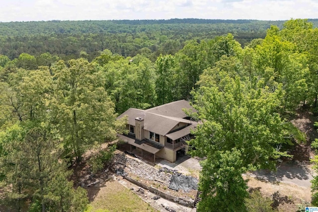 drone / aerial view featuring a wooded view