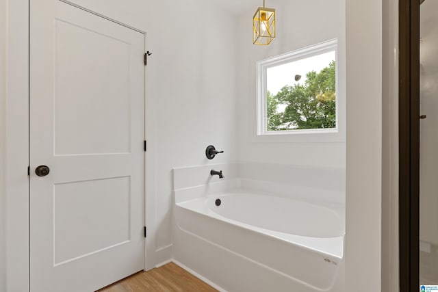 670 Hillstone Dr, Pell City, AL 35125 - full bath with baseboards, wood finished floors, and a garden tub