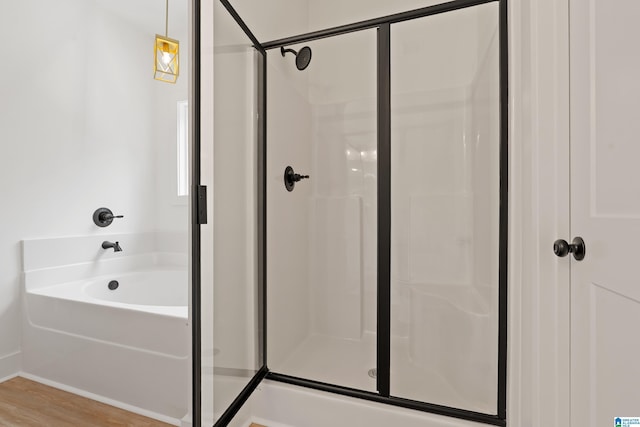 670 Hillstone Dr, Pell City, AL 35125 - bathroom featuring a stall shower, wood finished floors, and a bath