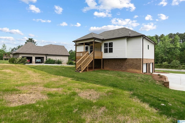 670 Hillstone Dr, Pell City, AL 35125 - rear view of property with driveway, an attached garage, a lawn, stairway, and brick siding