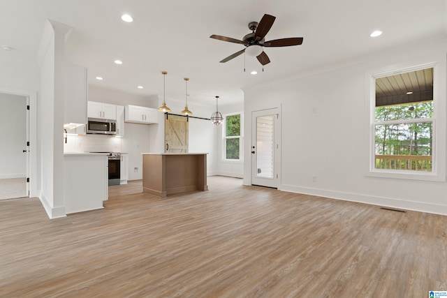 670 Hillstone Dr, Pell City, AL 35125 - unfurnished living room with baseboards, visible vents, a ceiling fan, and light wood-style flooring