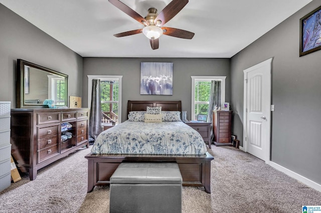 bedroom with ceiling fan, baseboards, and light carpet