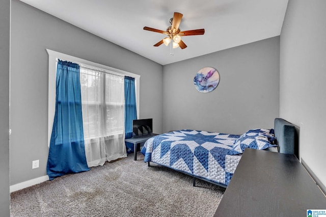 carpeted bedroom featuring a ceiling fan and baseboards