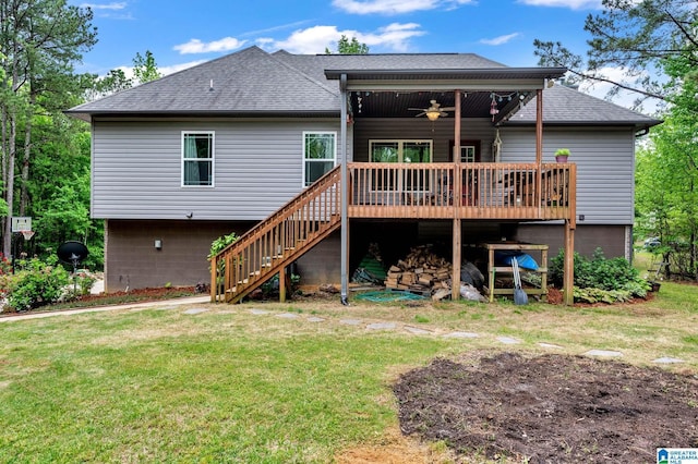 back of house featuring a lawn, stairway, ceiling fan, and a shingled roof